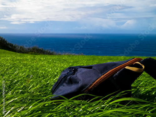 Obraz na płótnie Backpack on meadow. Sao Miguel Island. Azores. w salonie