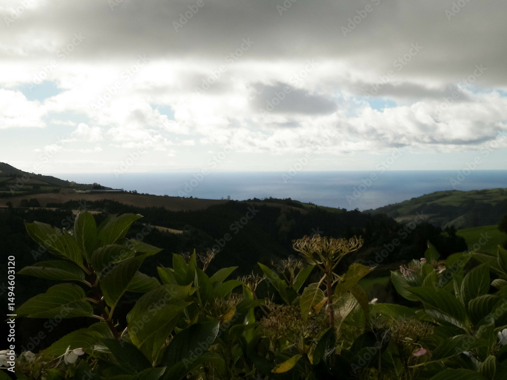 Typical landscape of Azores. Natural green fields hills and sea.