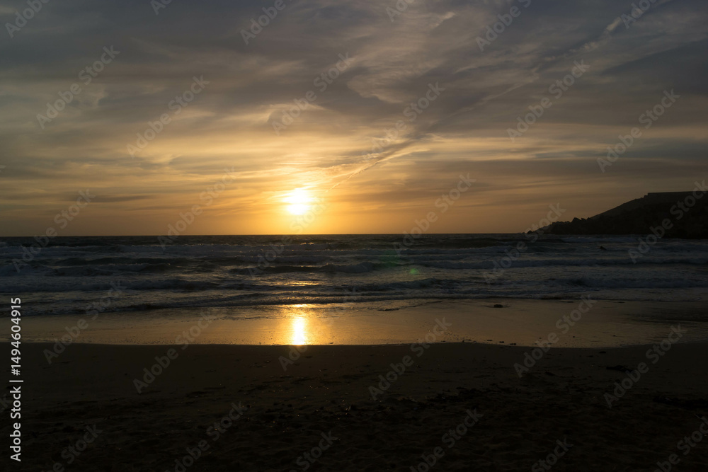 Stunning sunset over sea in Golden Bay Malta.