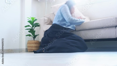 Woman suddenly faints and falls down while walking in the room, possibly from low blood pressure, heart problem, or passing out episode
