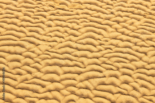 Top view of golden sand on ocean beach