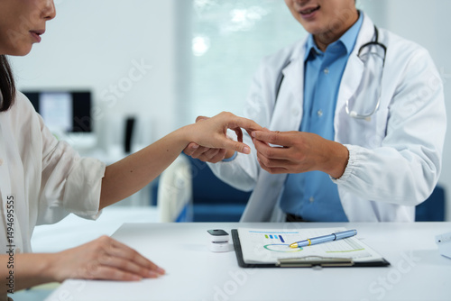 Doctor examining patient's hand in medical office, providing healthcare and medical attention