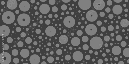 A monochromatic abstract pattern of overlapping circles with varying sizes and opacity, forming a textured and dynamic design on a dark background.