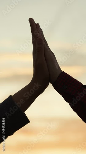 High five hands at sunset silhouette. Best friends buddies clapping each other palms in field park at dawn. Teamwork successfully completed business celebration rejoicing friendly feelings expression