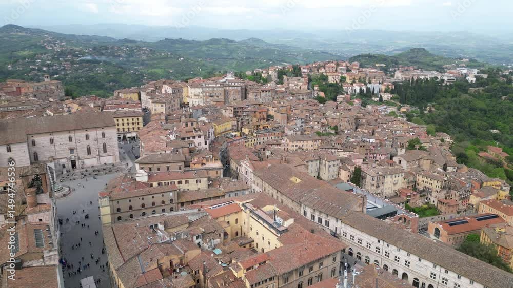 Drone aerial view of the historic center of Perugia with the houses perched on the hills of the Umbrian Apennines with the houses with the typical tiled roofs matching each other - Piazza IV Novembre Drone aerial view of the historic center of Perugia with the houses perched on the hills of the Umbrian Apennines with the houses with the typical tiled roofs matching each other - Piazza IV Novembre