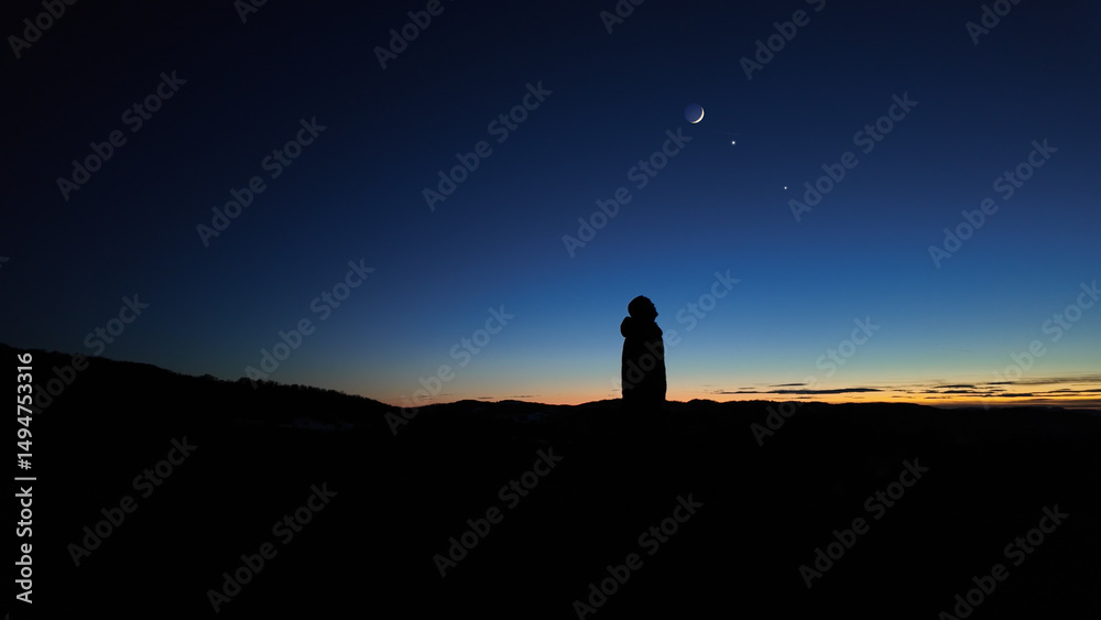 Fototapeta premium Silhouette of a man observing Milky Way stars, planets and other celestial objects from a dark countryside location.