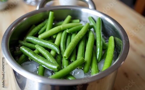 Boiled vegetables, green beans in ice water after blanching on a table. High quality photo