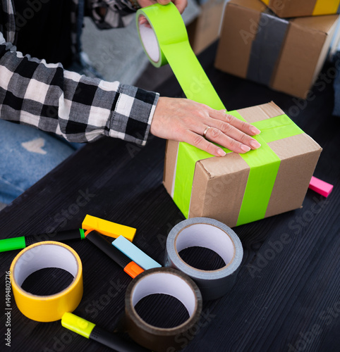 Girl Packing Cardboard Box At Home