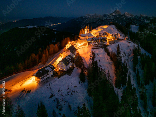 Night aereal view of Monte Santo di Lussari, Italy. The Di Prampero slope in Camporosso welcomed the new year with the longest torchlight procession in the entire Alpine arc.