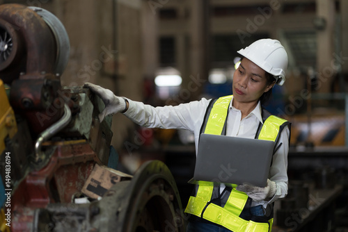 Worker, engineer woman, factory or storage warehouse. Engineer working with laptop computer in industry factory, inspection of machine for manufacturing, maintain, controlling factory operation