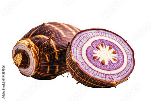 Fresh organic taro root cut in half on black background