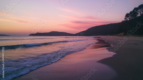 A serene beach scene displays the sun setting over the ocean
