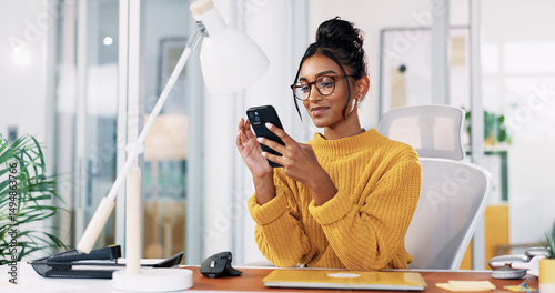Office, Indian woman and glasses with smartphone for reading, blog post and online communication. Smile, business person and journalist on break with mobile, news application and chat on social media