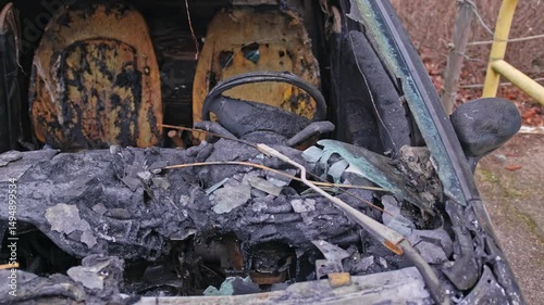 Burnt Electric Car Wreck with Melted Interior and Tires Caused by Battery Fire