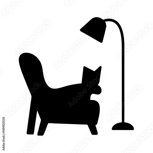 Stylized black and white image depicts a cat napping in armchair under lamp