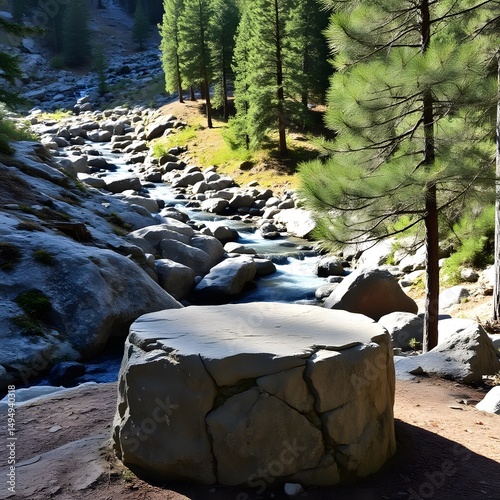 Stone podium near a mountain stream with pine trees in the background.

