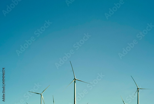 Wind turbines under a clear blue sky generating clean renewable energy. Austria