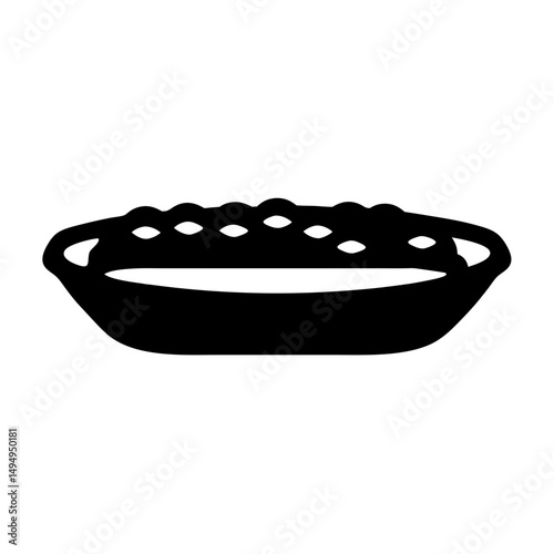 A silhouetted black and white image of a small fruit tart