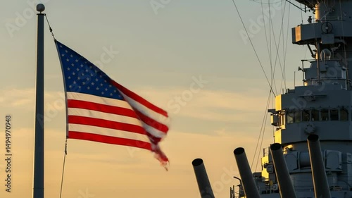 Historic warship and american flag at sunset