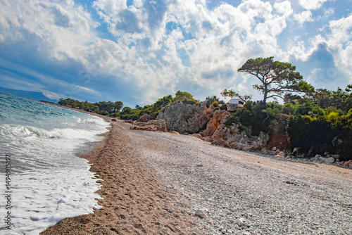 Fototapeta Naklejka Na Ścianę i Meble -  beautiful pebble beach with rocks and fir trees in Kemer Turkey in September