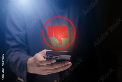 Man using smartphone or tablet, pointing finger at dislike button, thumbs down button, Interface,Thumbs up icon, display screen, touch screen, Virtual Image Technology
