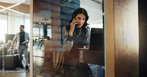 Laptop, lobby and phone call with business woman in pod at hotel for communication or update. Computer, conversation and hybrid work with mature employee in cubicle for accounting or finance feedback