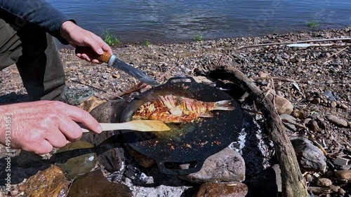 Cooking food over a fire outdoors