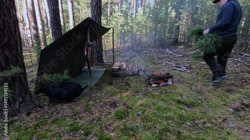 They are busy building a shelter in the forest.