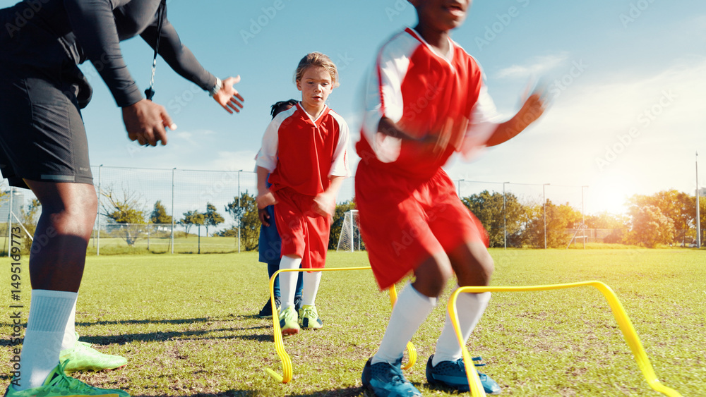 Obraz premium Group, children and jump for soccer practice for fitness training, balance exercise and sports workout. Kids, drills and hurdles for playing game, learning skills and team challenge of match activity
