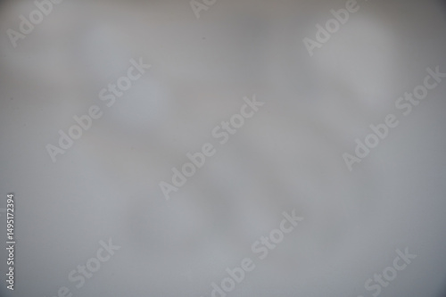 A blurry gray background with a white line. The line is white and is on the right side of the image