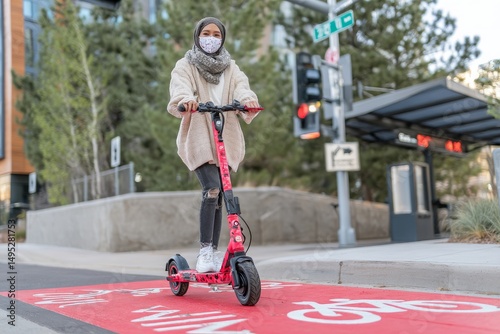 Woman riding electric scooter along red bike lane with signs of bicycles and two way arrows on street, representing traffic, city transport and people concept
