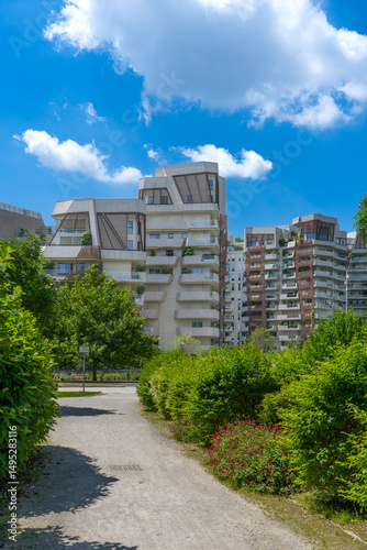 Libeskind Residences in CityLife Milan on a sunny day with urban park and people walking, modern luxury architecture in Lombardy