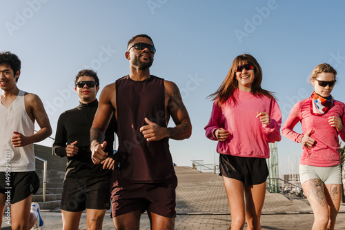 Εκτύπωση καμβά Group of five athletes running and smiling, outdoors