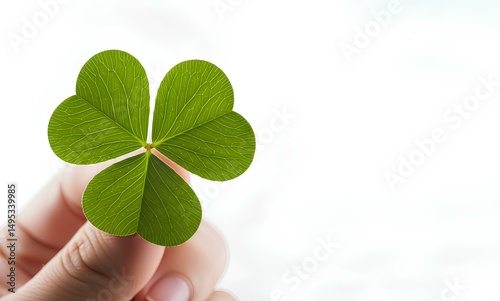 Hand holding a four-leaf clover mockup isolated on white background, for St. Patrick's Day visuals, luck symbolism, or positive energy branding photo