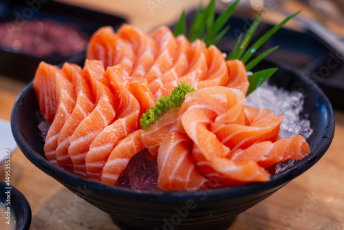 High angle view of salmon seafood in black bowl on table