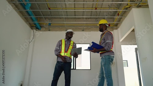 Construction engineers and foremen are inspecting the construction within a housing project.