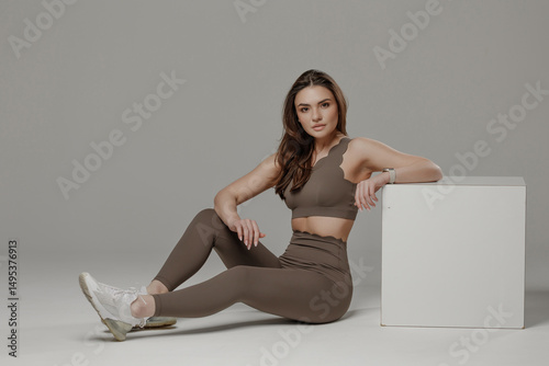 Wallpaper Mural Model poses in stylish activewear against a neutral background showcasing fitness and fashion Torontodigital.ca