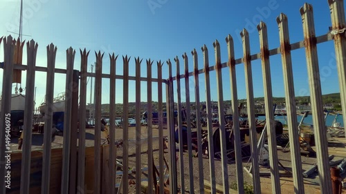 Boatyard and Rusted Fence Overlooking Howth Harbour in Ireland. For editorial use only.