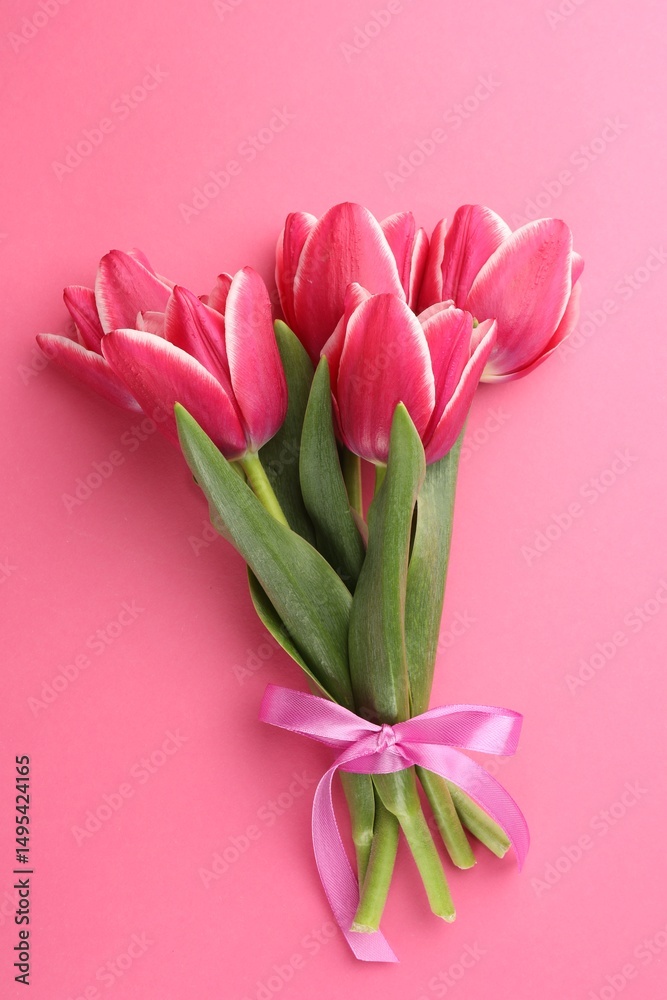 Fototapeta premium Bouquet of beautiful tulips on pink background, top view