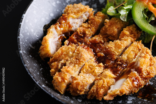 Gourmet meal featuring delicious fried chicken wings and crispy fried chicken with rice served on a white plate as a hot cooked dish of poultry cuisine with savory sauce
