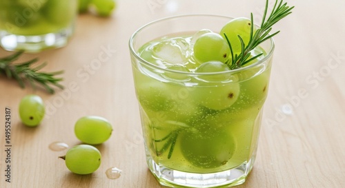 Fototapeta Naklejka Na Ścianę i Meble -  A beautifully crafted green grape cocktail with fresh rosemary, ice, and grapes.