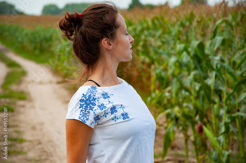 Woman wearing Ukrainian embroidery called Vyshyvanka in field. Ukrainian national clothes. Ukrainian girl in countryside. Independence day of Ukraine. Vyshyvanka day. 15th May. Revival of traditions