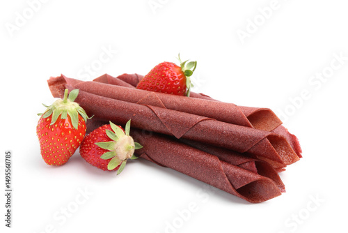 Tasty fruit leather rolls and strawberries isolated on white photo