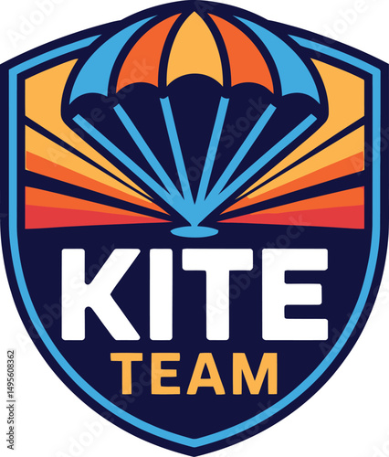 Kite team logo with parachute graphic in blue orange and white on a shield shaped emblem design