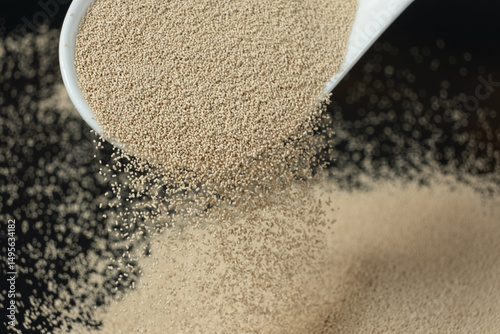 Fényképezés Dry yeast is poured out of a spoon