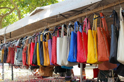Colorful fashion leather bags sold outside on a market stall