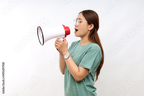 Serious woman of Asian hold scream shout in megaphone announces discounts sale hurry up isolated on white background studio portrait.
