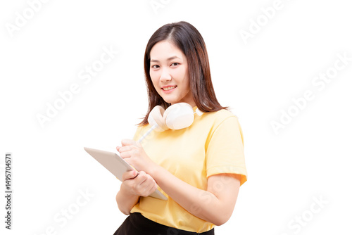 Young woman with headphones around her neck holding a tablet and smiling.