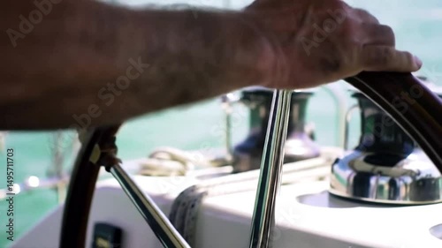Wallpaper Mural A hand is steering the rudder on the boat, man on steering wheel navigating sail boat. Torontodigital.ca
