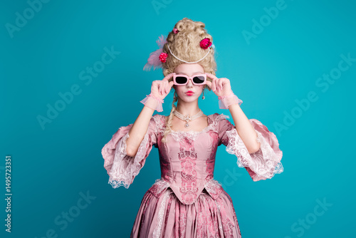 Photo of young woman wear baroque dress cosplay Marie Antoinette isolated on teal color background
